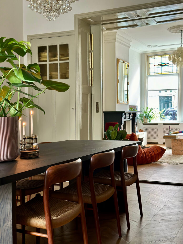 European dining room with walnut furniture and classic stools.