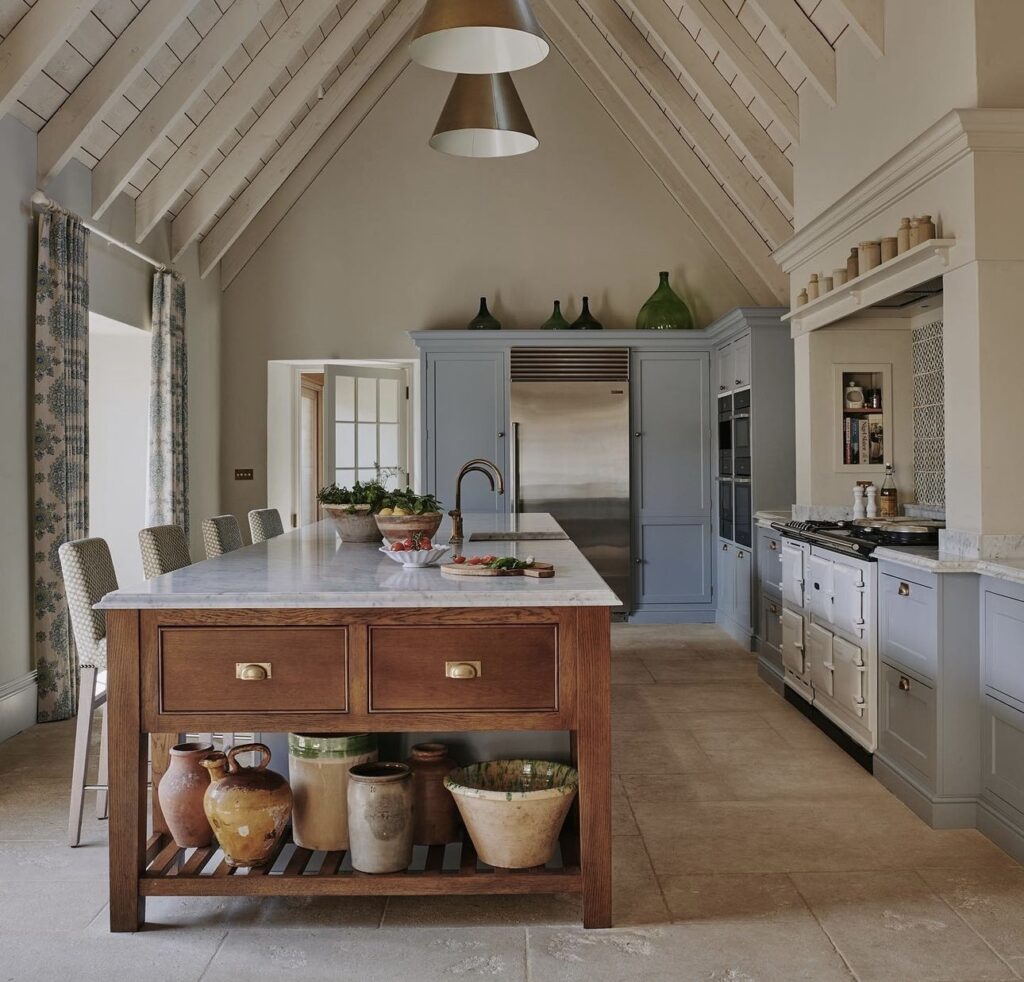 British, Scandinavian country kitchen with high ceiling and light blue cabinets.