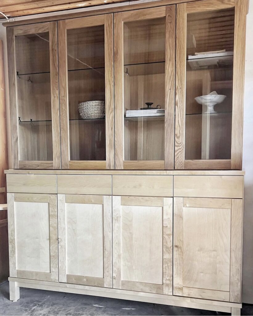 Plain cabinet in wood with glass doors.