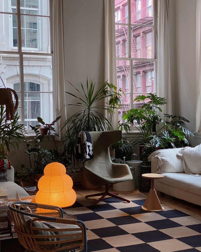 Moody living room with a large brown and black checkered rug in wool.