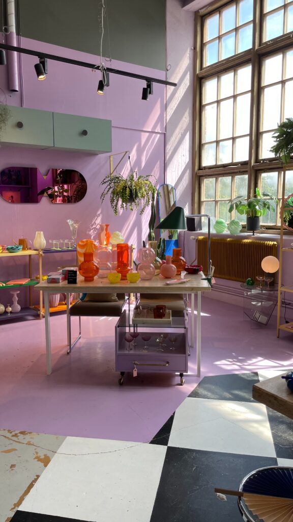 Purple walls and a big window in a Scandinavian colorful interior design store.