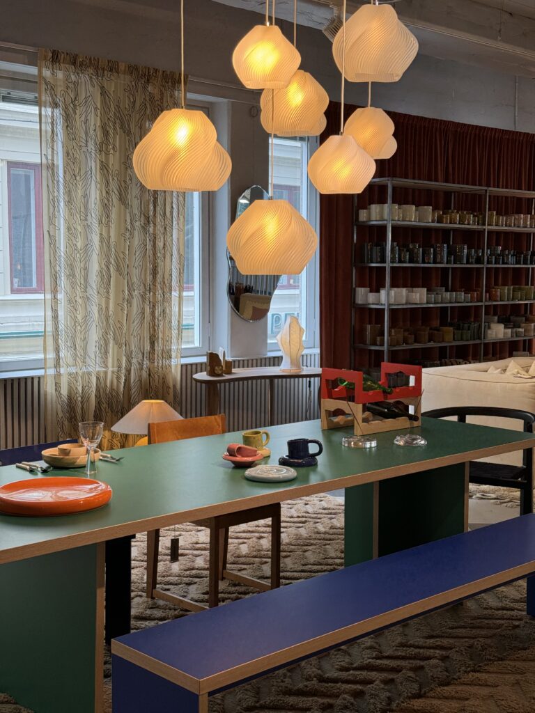 Table setting with colorful table and bench in the interior design store Vallgatan 12 in Gothenburg Sweden.