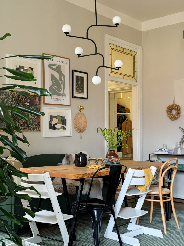 Dining area with different types of chairs in brown, green and wood