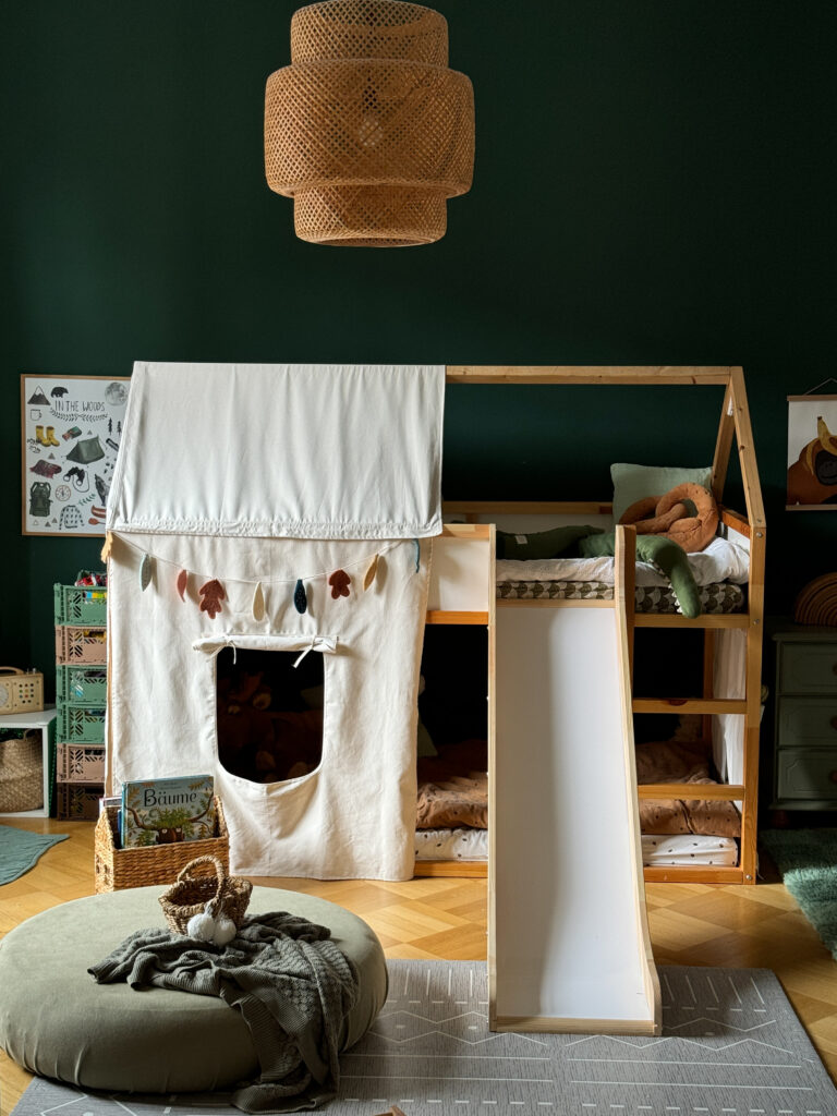 Kids room with bunk bed from IKEA and a slide going down from it.