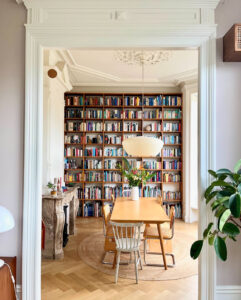 Turn of the century home with large floor to ceiling bookshelf and original details.