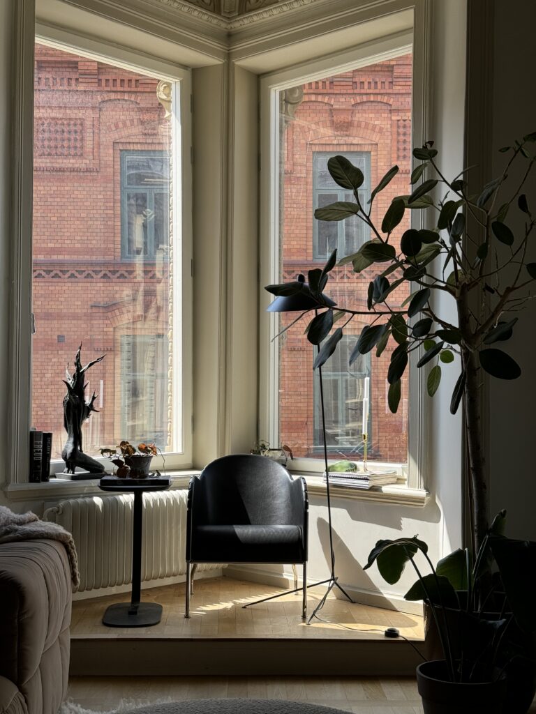 Beautiful bay window in a turn of the century apartment furnished with beautiful luxurious furniture.