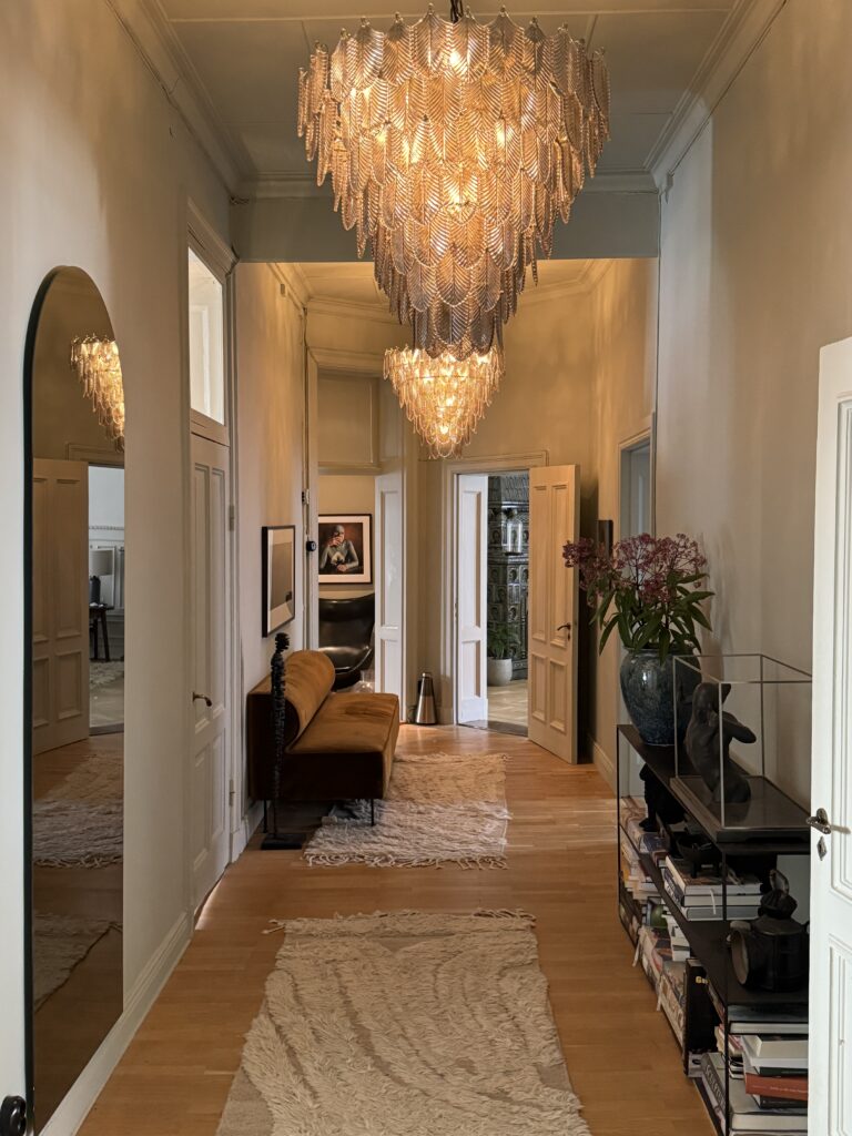 Hallway with big chandeliers, ideas on how to furnish long hallway.