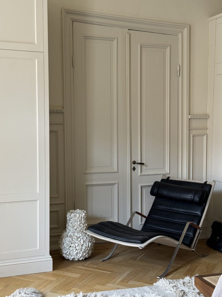 Turn of the century apartment with a beautiful lounge chair.