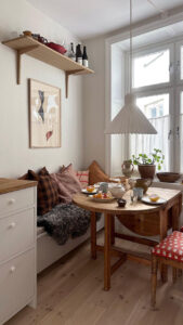 Small dining area in a Scandinavian apartment in Stockholm Sweden with a built in banquette