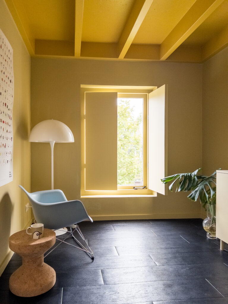 Yellow room with designer furniture and details.